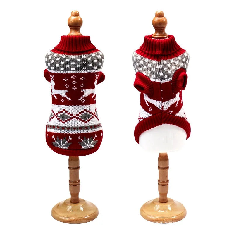Two red and white patterned dog sweaters on wooden mannequins against a white background.