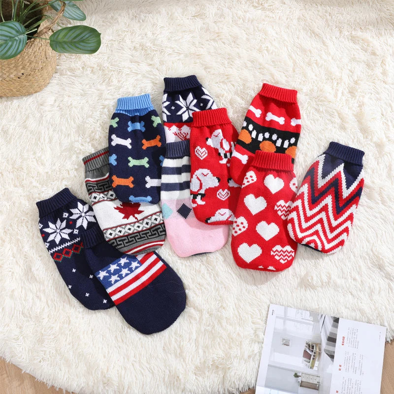 Collection of colorful dog socks with various patterns on a fluffy white surface.